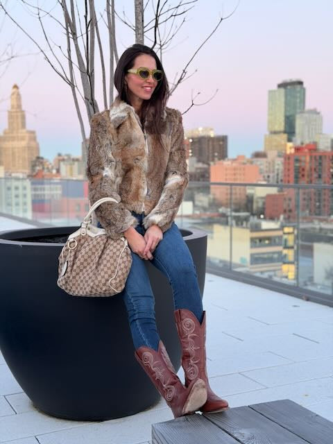 Woman sitting on a rooftop with a cityscape background